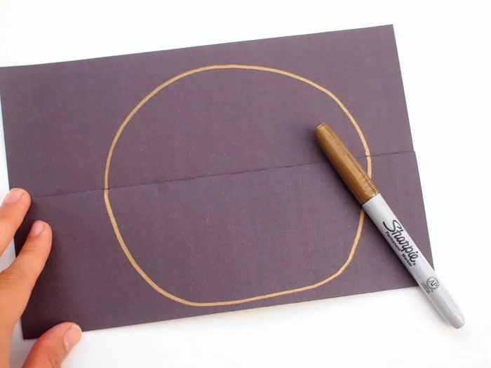 Circle drawn with gold Sharpie on the construction paper