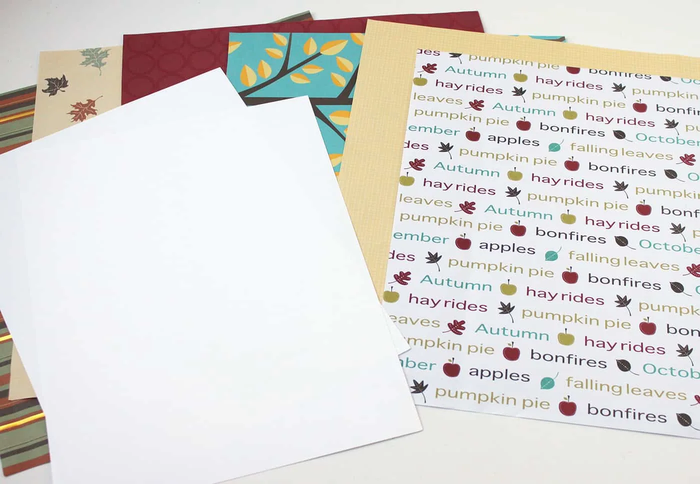 Various autumn scrapbook papers and white cardstock