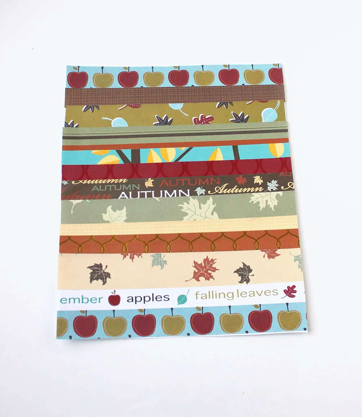 Strips of fall scrapbook paper glued onto a white cardstock background