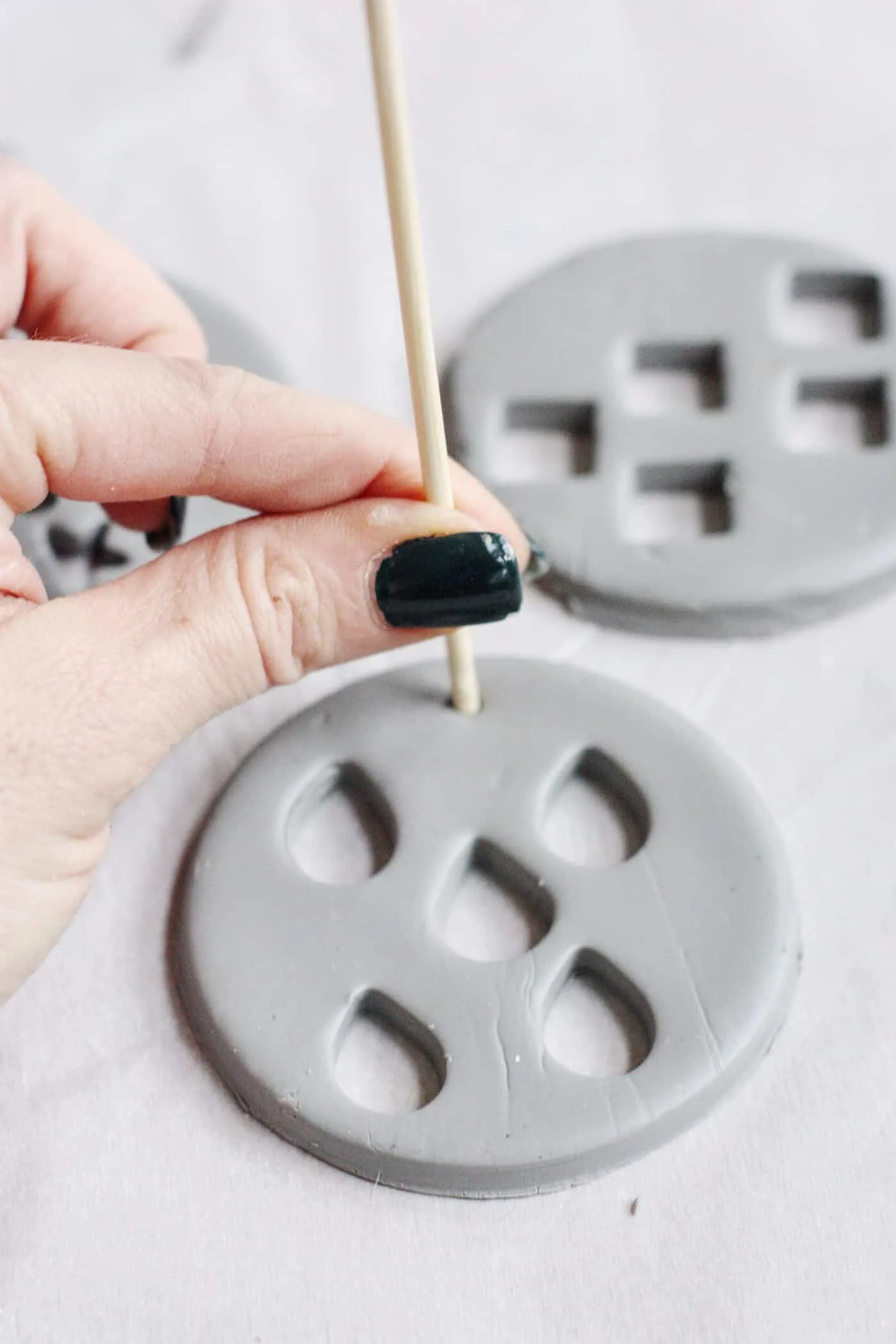 Press a hole into the top of a clay ornament using a skewer