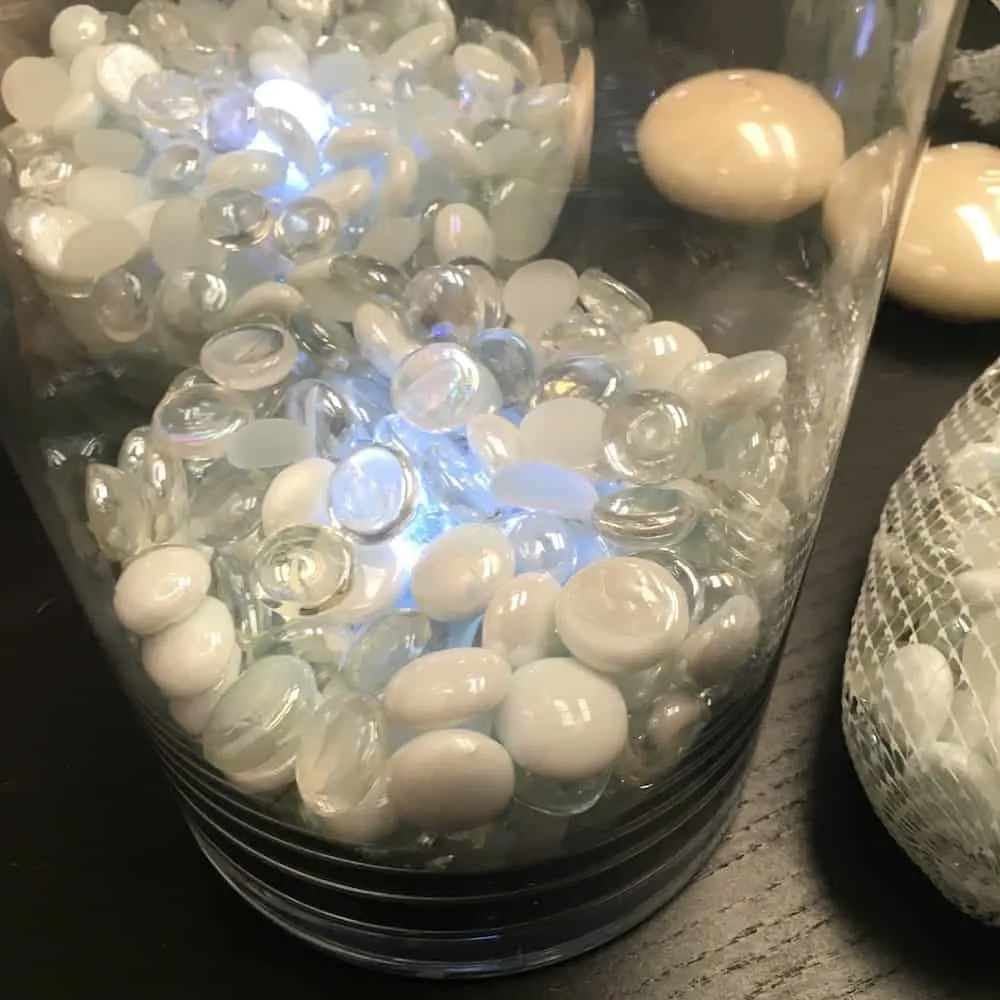 White and clear marbles over the top of an LED light