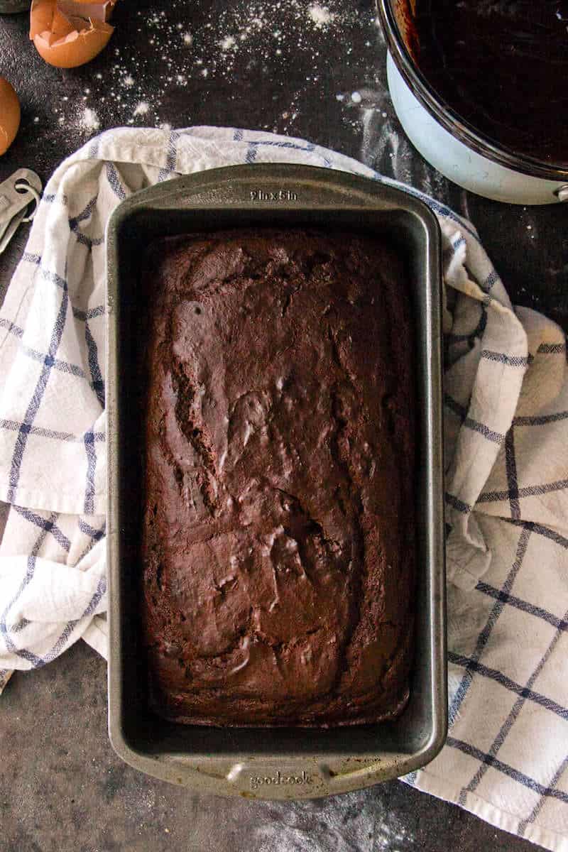 Chocolate pumpkin bread loaf cooling in a bread pan