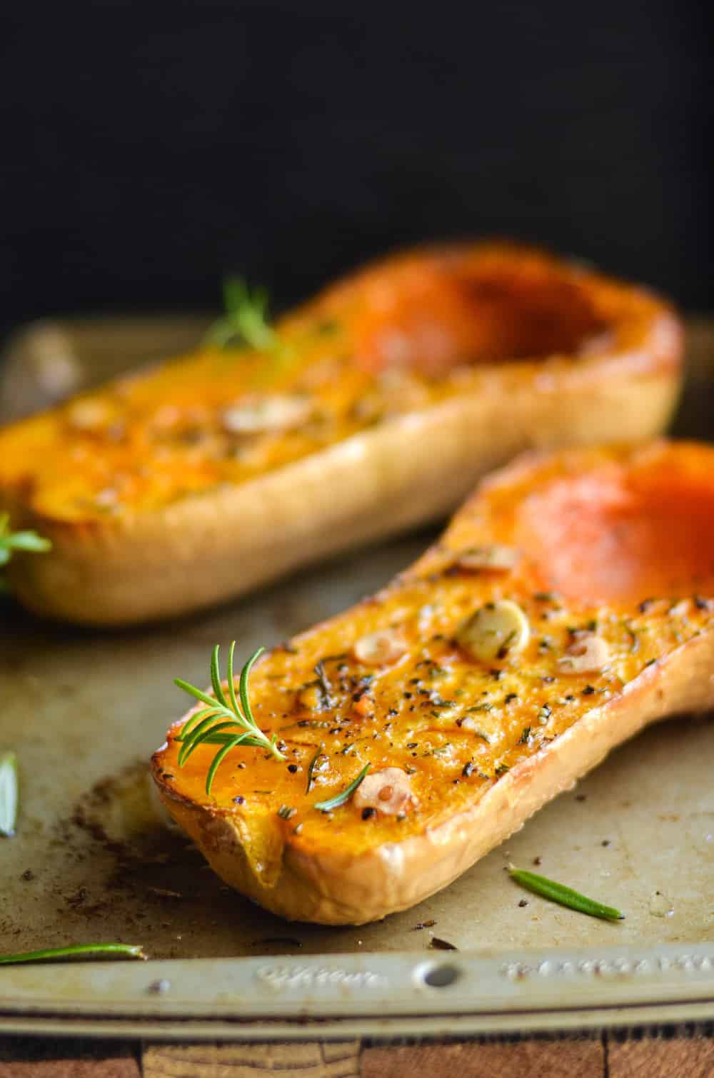 The garlic and rosemary make this roasted butternut squash recipe! Perfect for a weeknight dinner or even a side for a holiday.