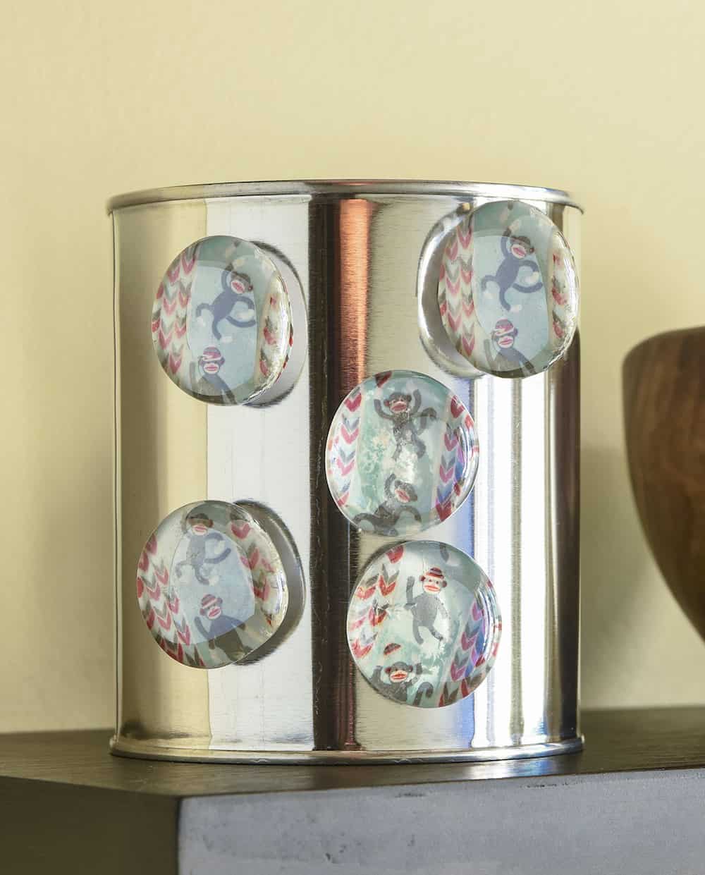 Learn how to make these easy personalized magnets using washi tape, flat glass marbles, and spray adhesive. You can make a ton of these for gifts or for your own fridge using a few simple supplies!