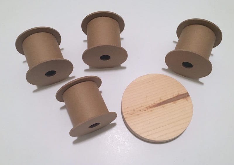 Four ribbon spools and a wooden plaque