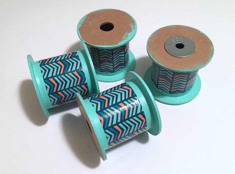 Four painted ribbon spools with Duck Tape