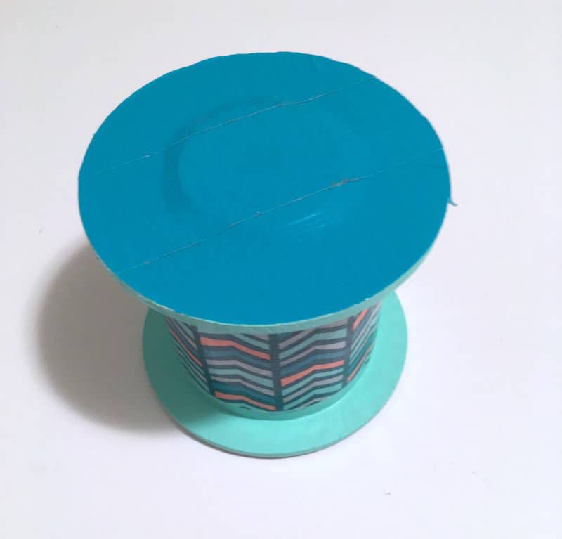 Ribbon spool with teal Duck Tape on one end