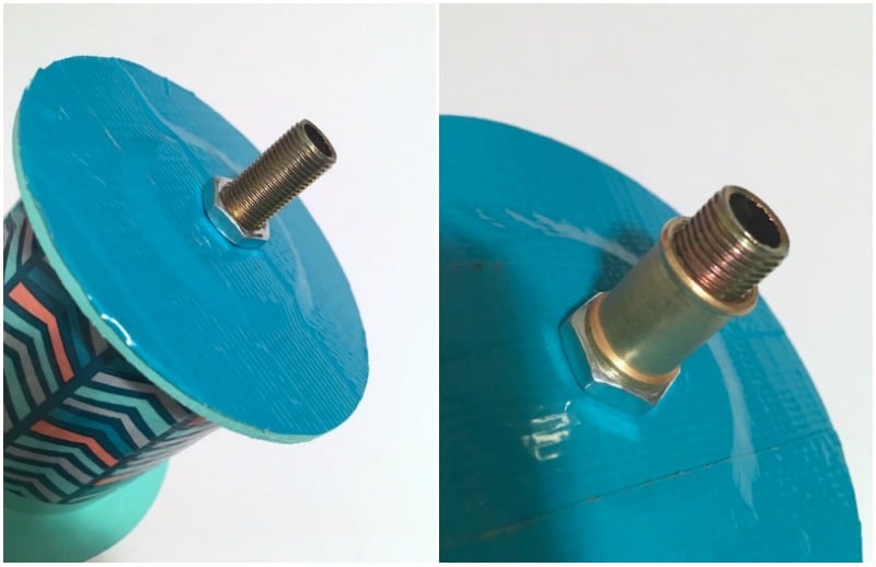 Fixture pipe and a locking nut sticking out of one end of a ribbon spool