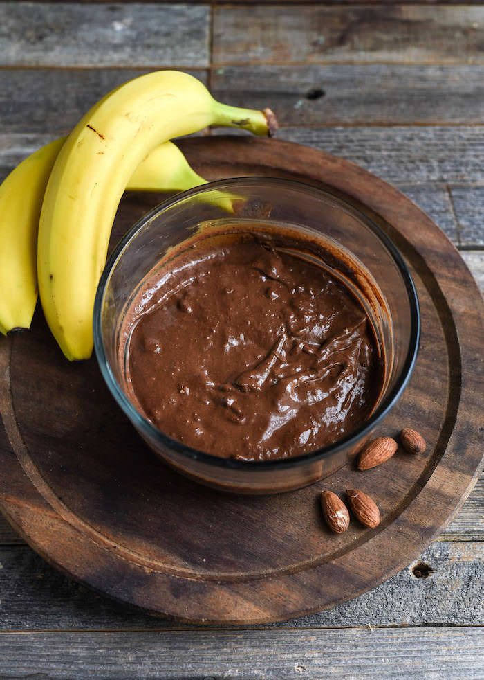 mashed bananas, cocoa powder and almond butter mixed together in a glass container