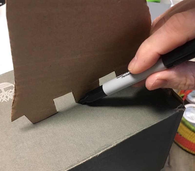 Making lines on the shoe box with a Sharpie