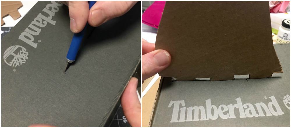Cutting slits into the shoebox with a craft knife and then inserting cardboard tabs