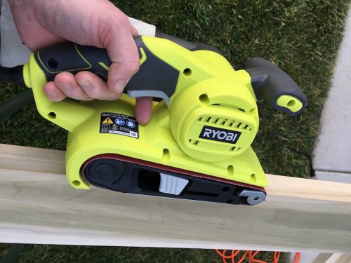 Ryobi belt sander on a piece of poplar