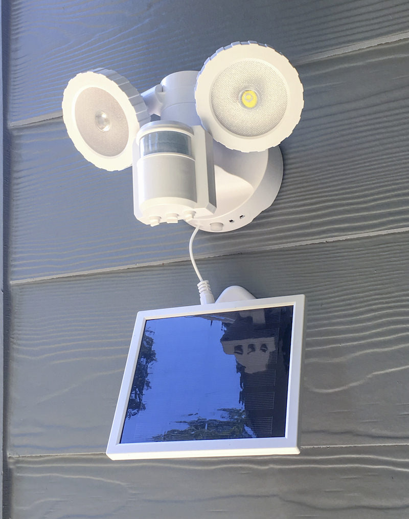 Hanging solar light on the side of a house