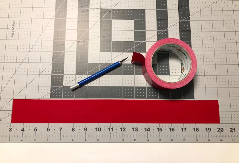 Place a piece of Duck Tape on a cutting mat