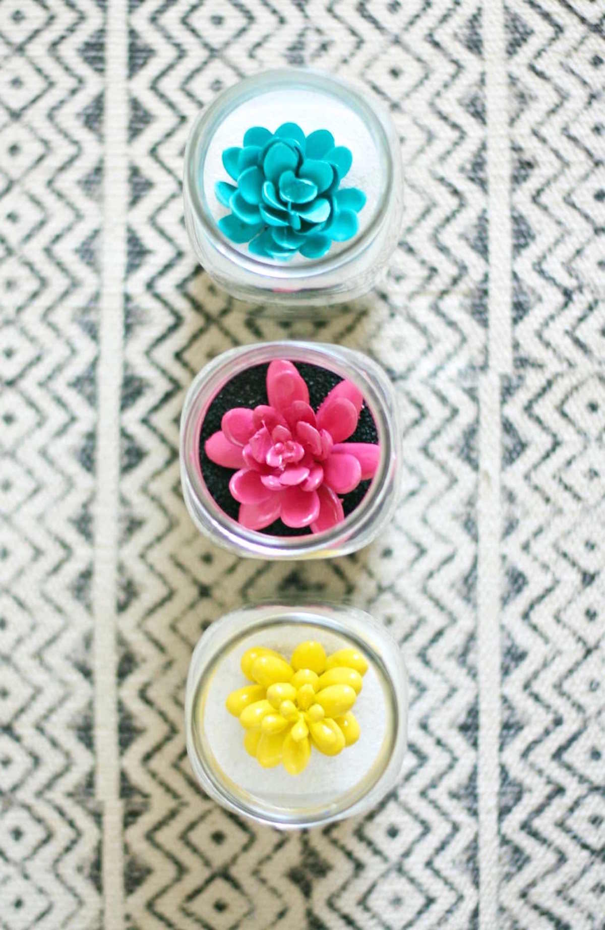 Facing down on three sand jar art projects