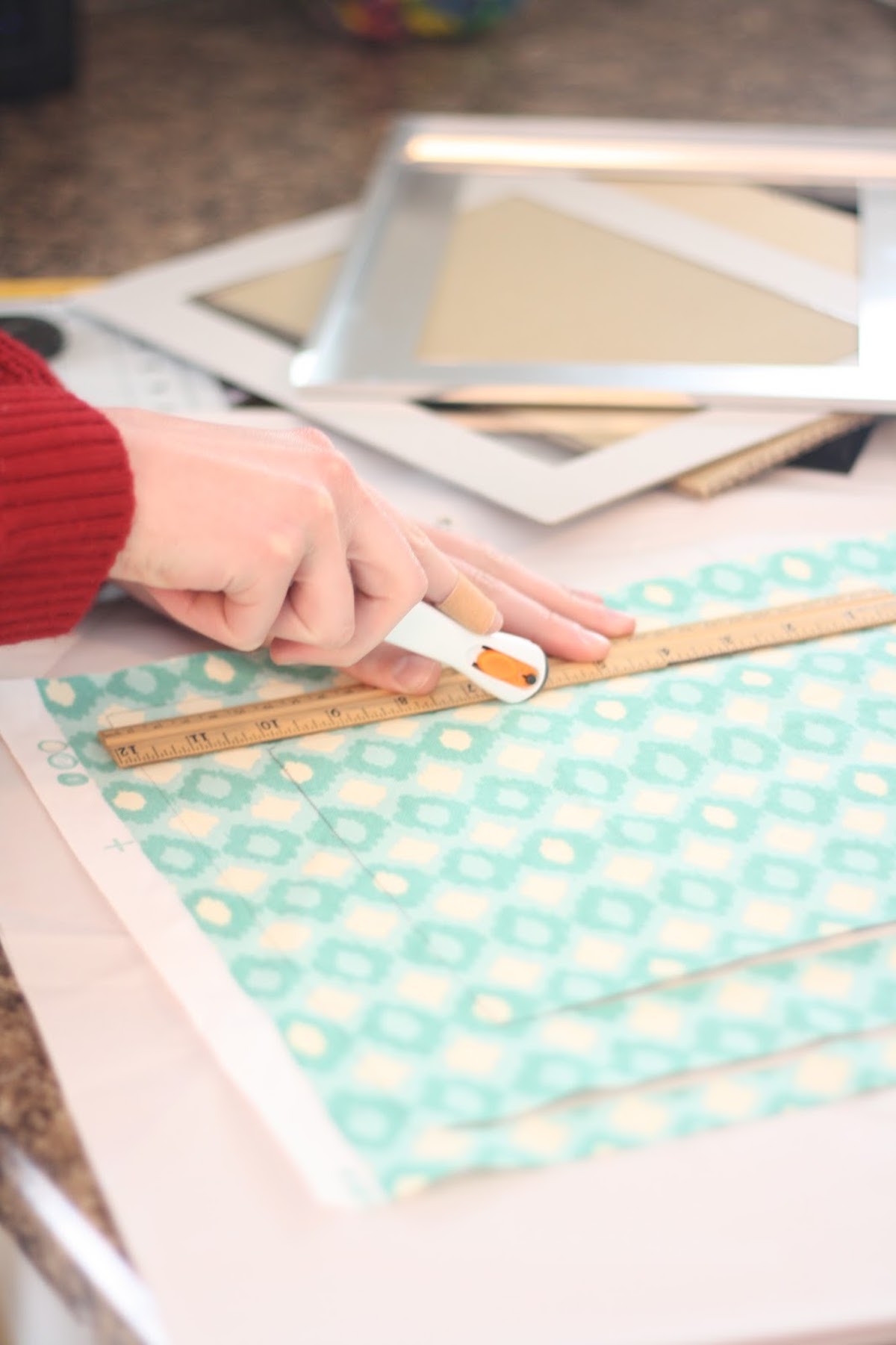 Woman cutting fabric using a cutter and a ruler