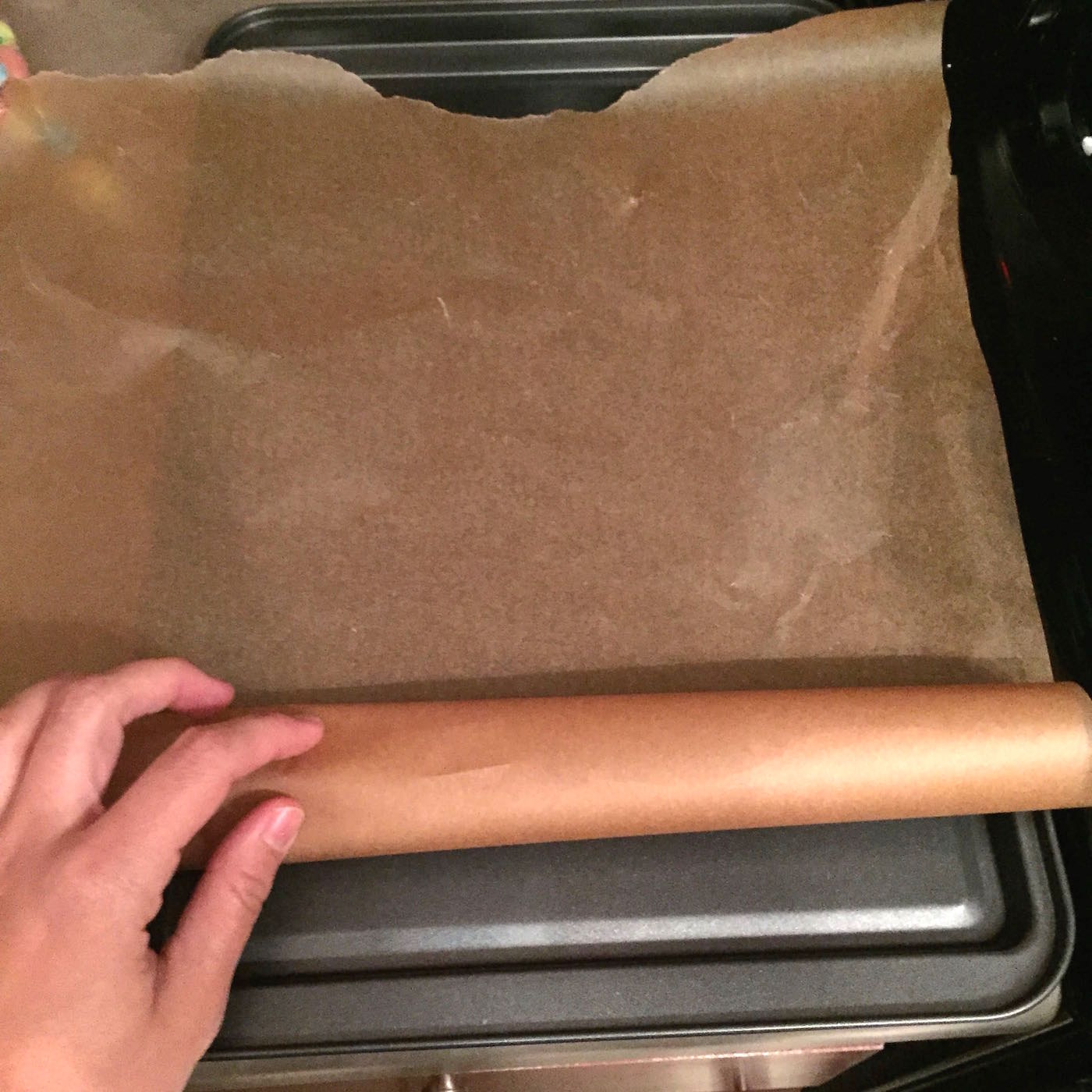 Adding parchment paper to a cookie sheet
