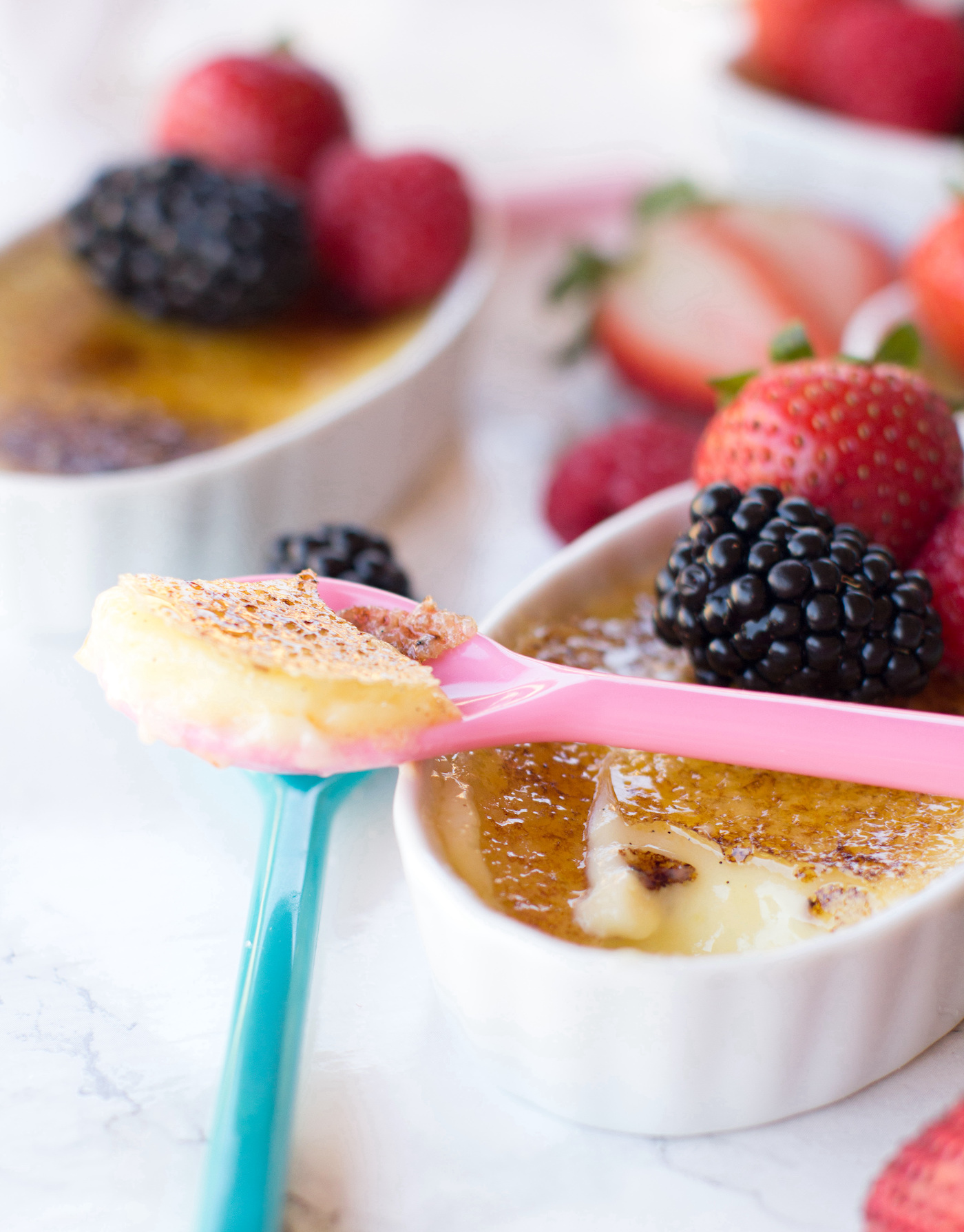 creme brulee with fruit on a spoon