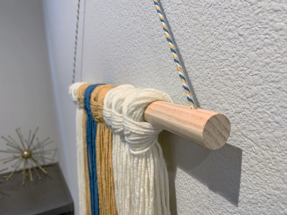 yarn wall hanging shown from the side