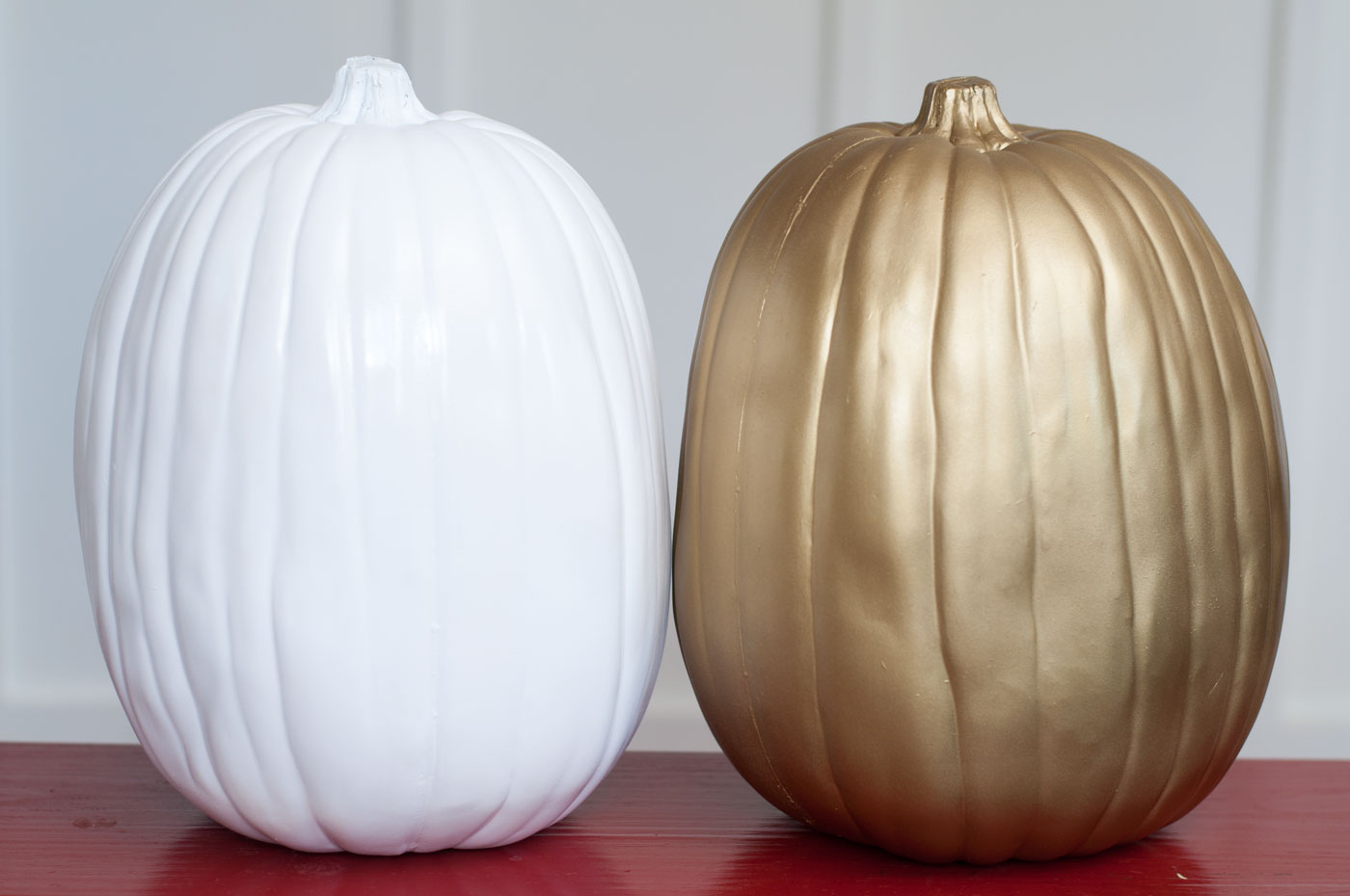 Faux pumpkins spray painted white and gold
