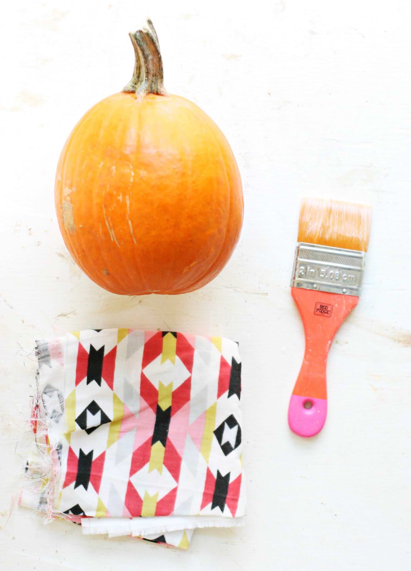 Piece of fabric, pumpkin, and paintbrush