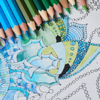 Colored-pencils-sitting-on-top-of-coloring-page