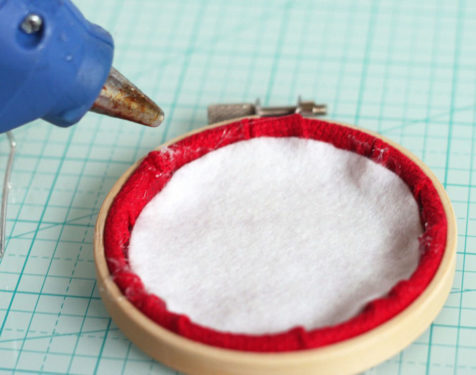 Gluing a felt circle to the inside back of the ornament