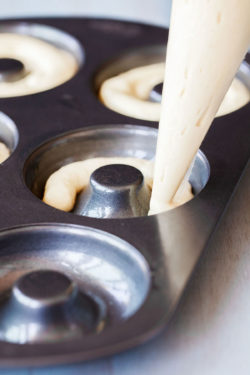 Adding cake mix batter to a donut pan