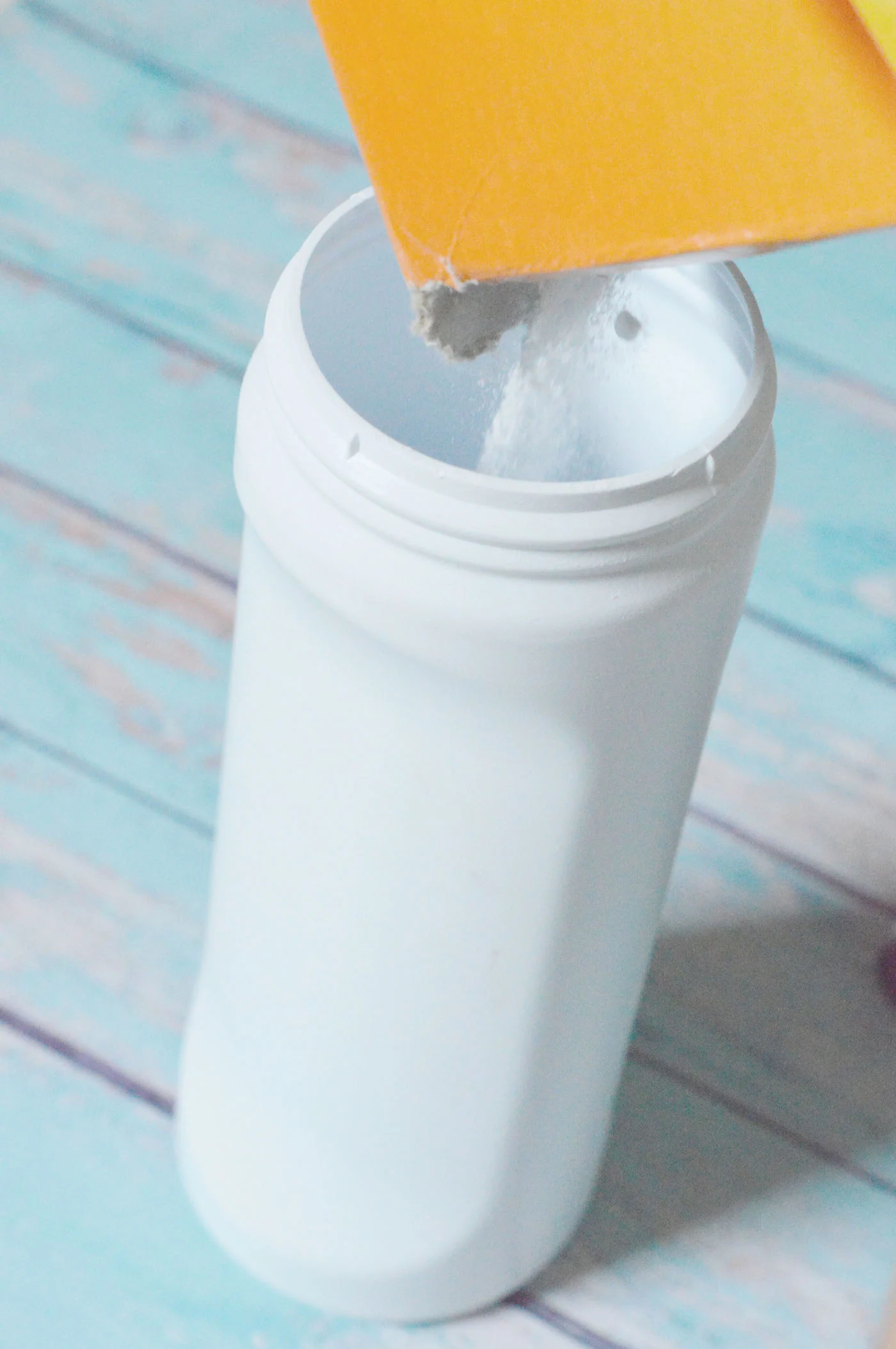 Adding baking soda to the bottle