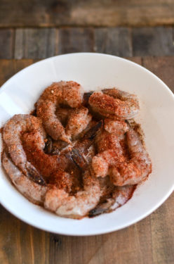 Raw shrimp with seasoning in a white bowl