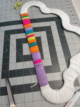 rainbow yarn wrapped around the bottom of the cloud shape