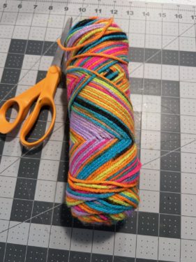 skein of rainbow yarn and scissors