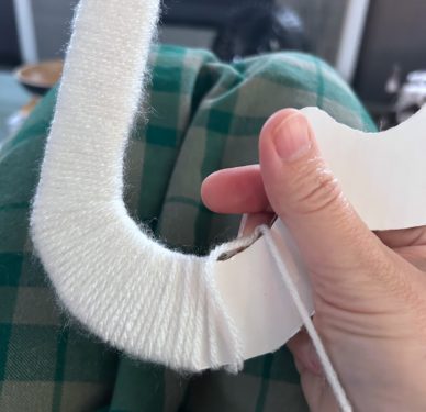 wrapping white yarn around the cloud shape