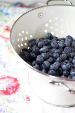 Blueberries in a white ceramic colander