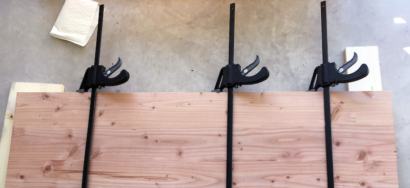 Clamps holding three boards together