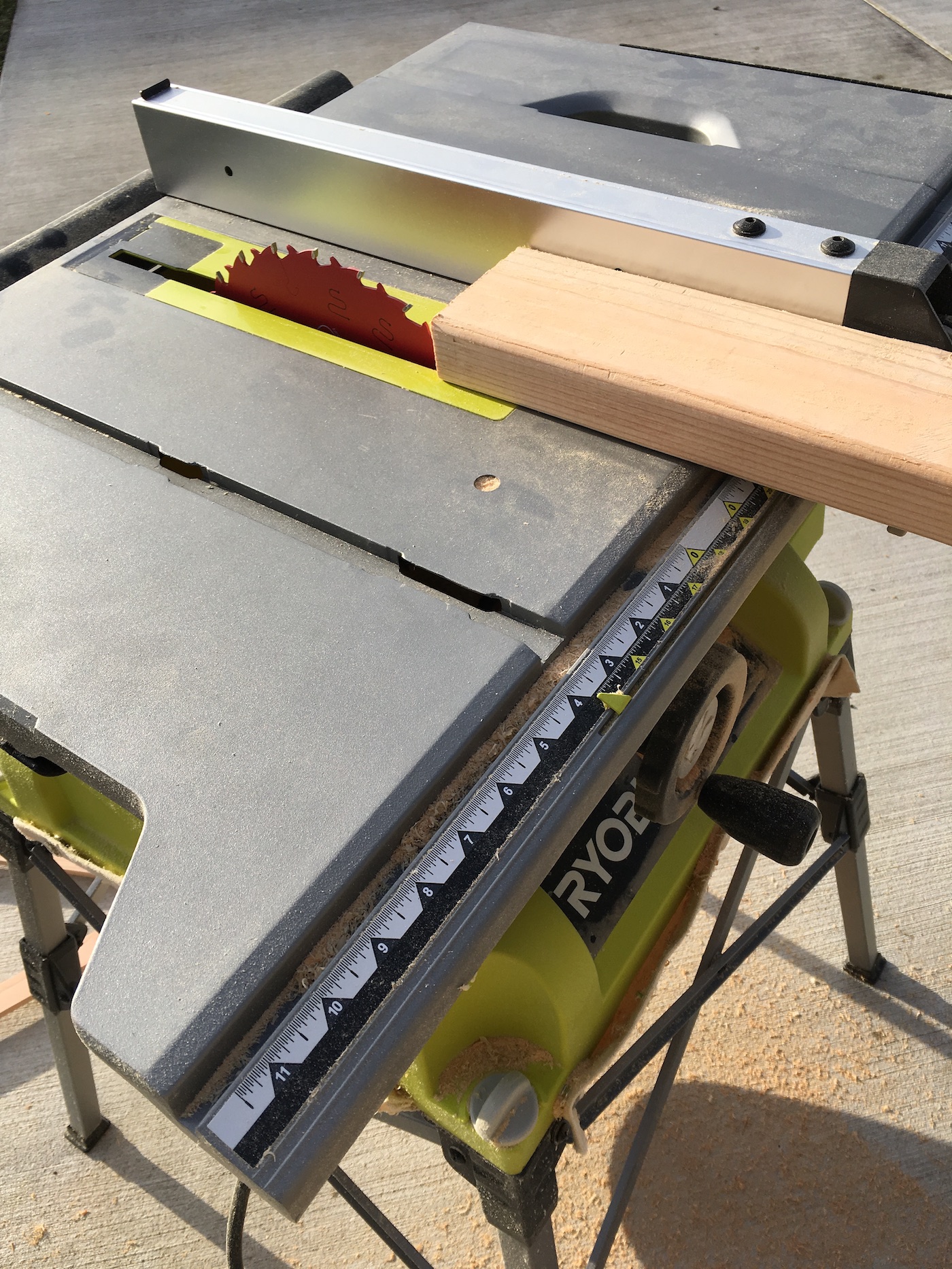 Cutting a wood board with a Ryobi table saw