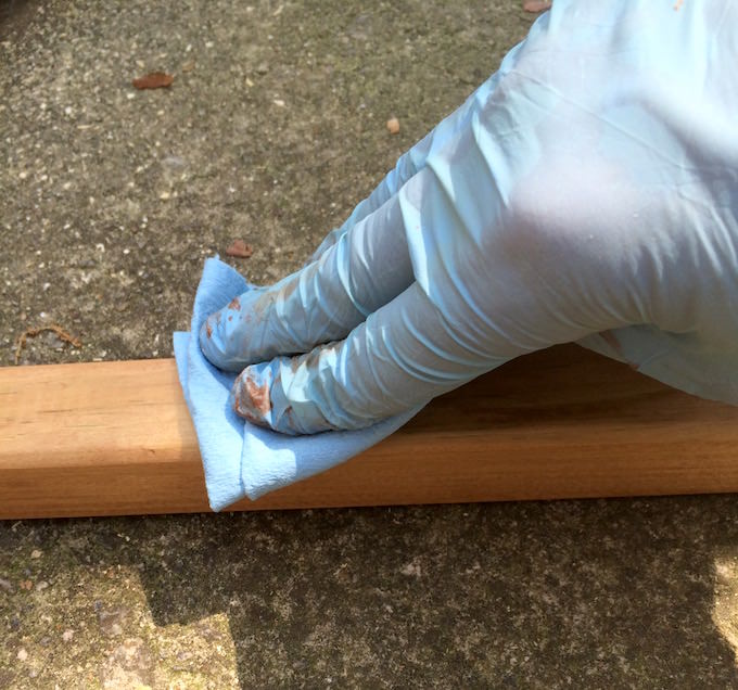 Wiping away stain from 2x2s with a rag