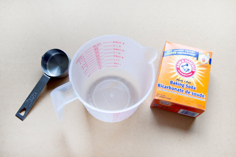 Baking soda castile soap in a measuring cup and a small measuring cup