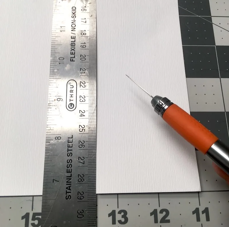 Cut a strip of paper using a metal ruler and craft knife