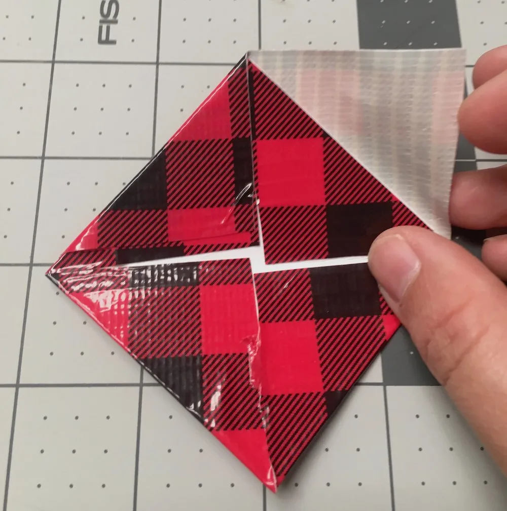 Tape the smaller triangle to the larger square