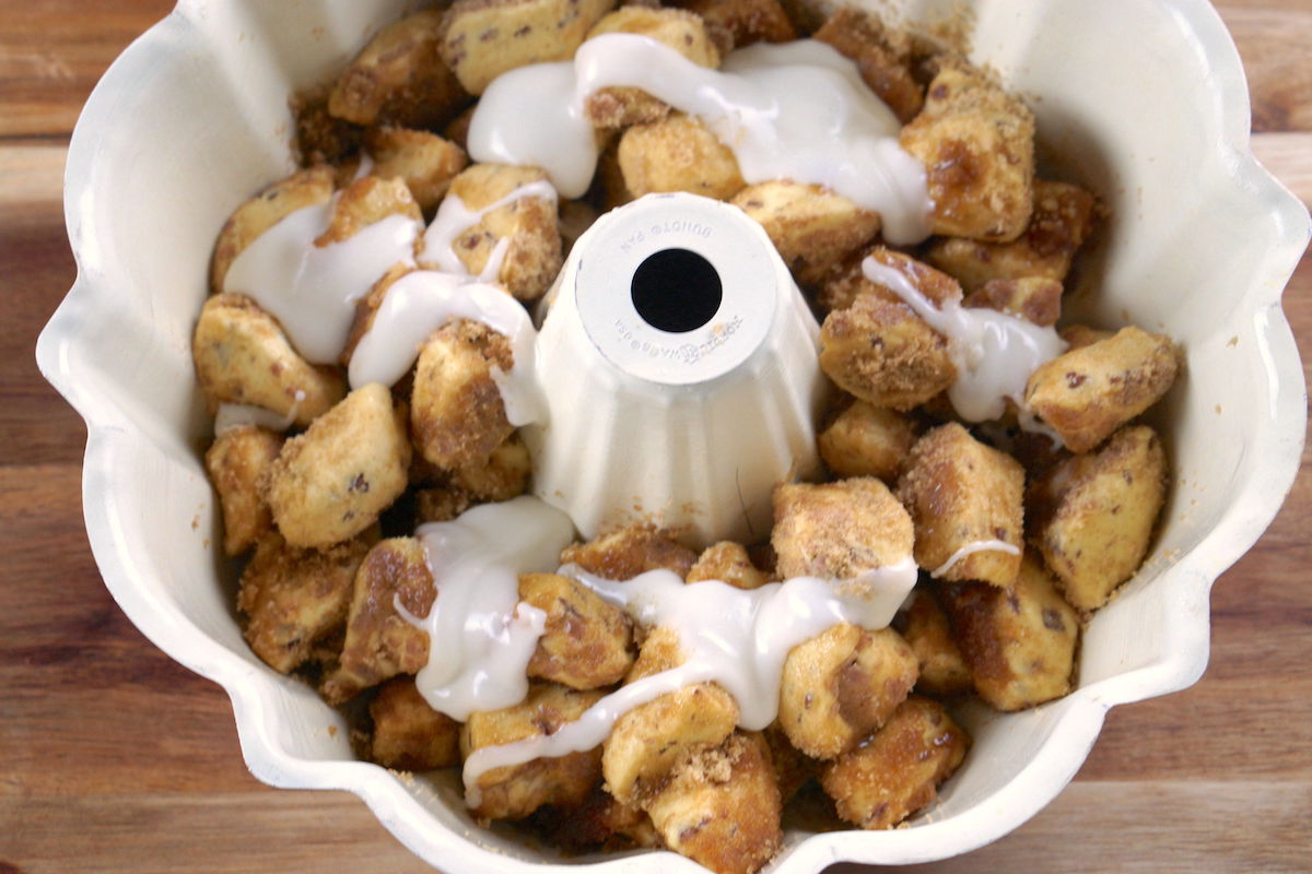 Glaze drizzed on top of pumpkin monkey bread pieces