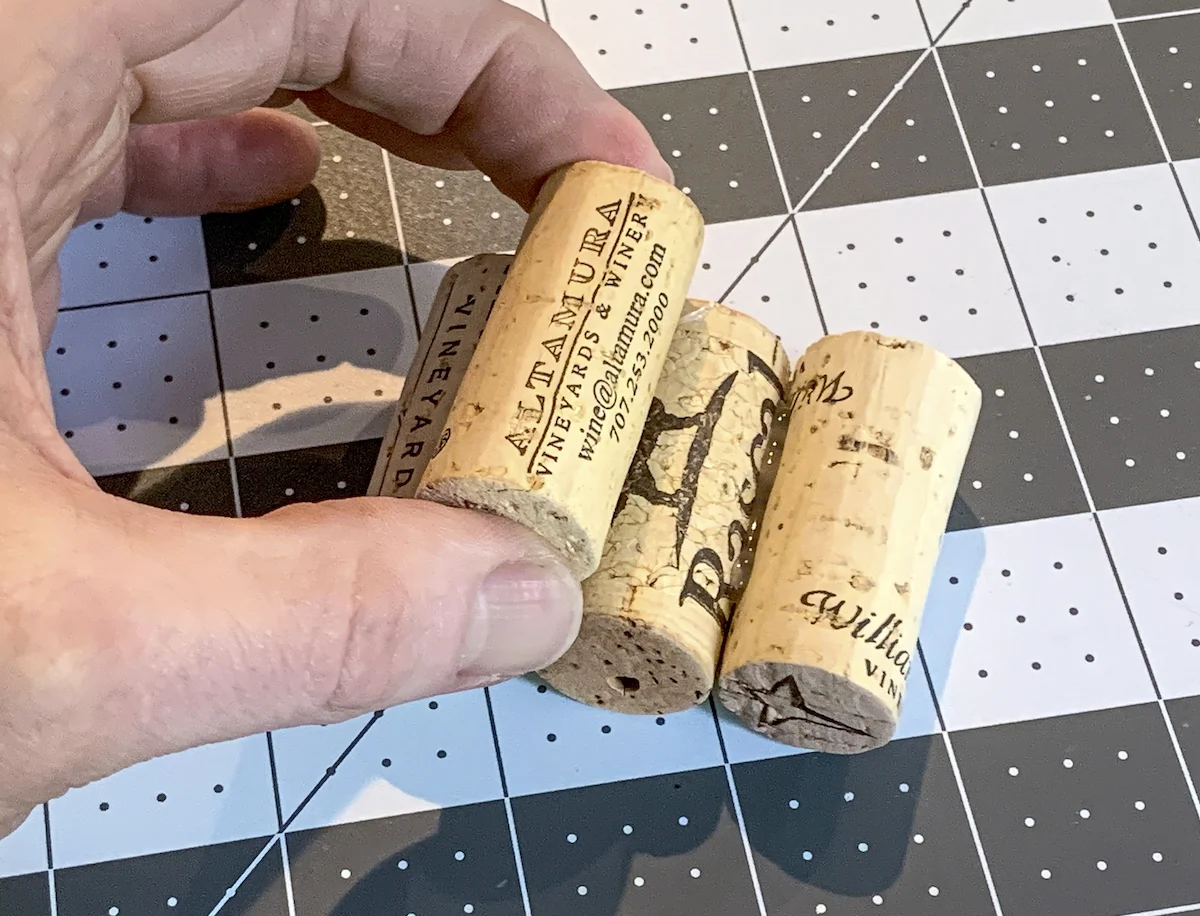 Hot gluing rows of wine corks on top of each other