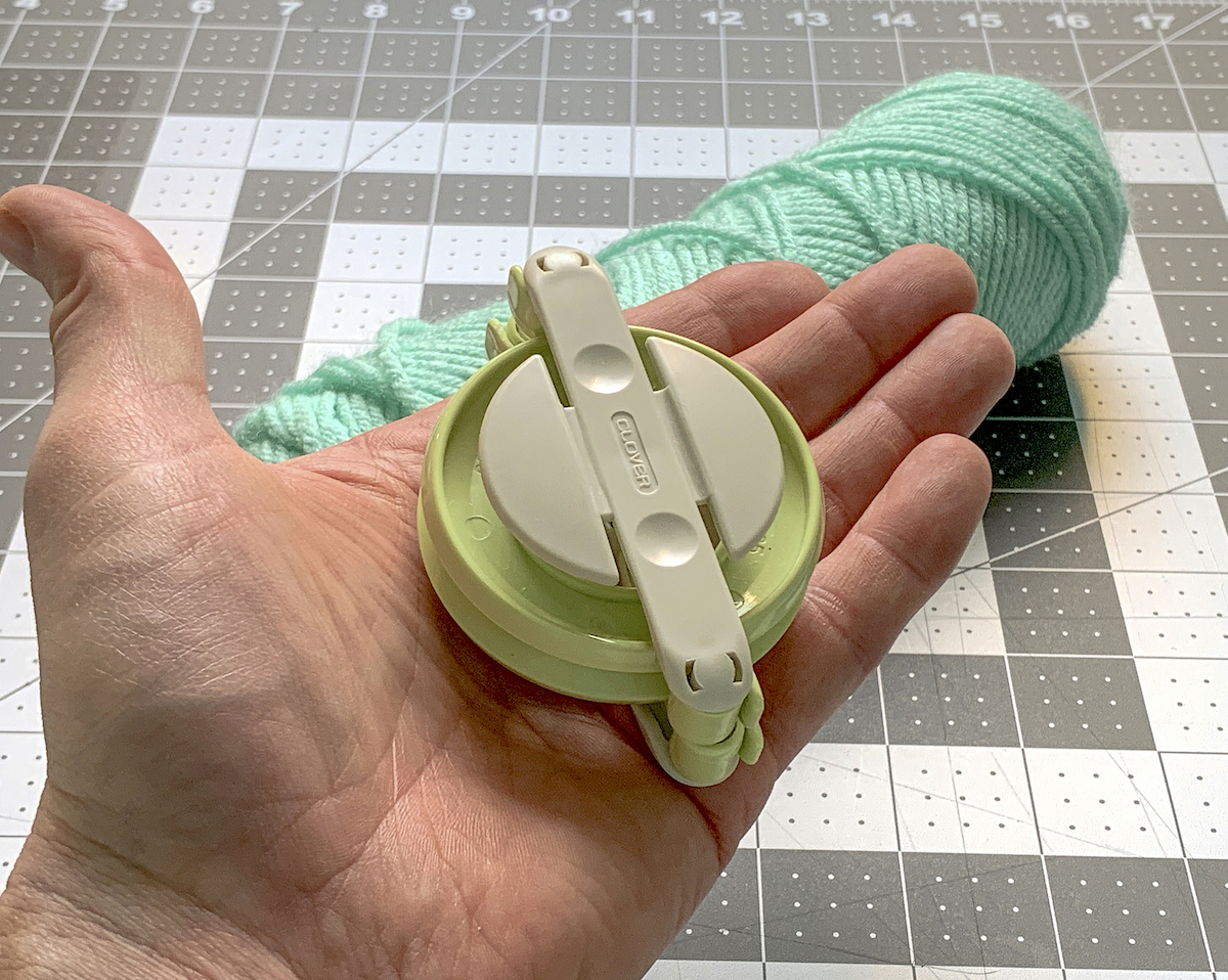 Pom Pom maker in a hand