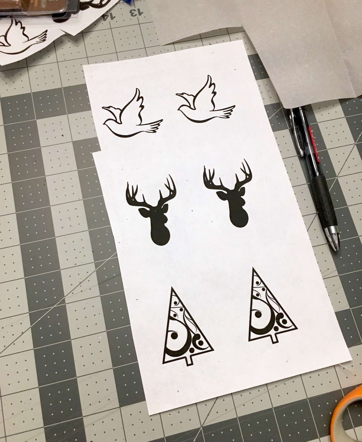 Sheet of ornament designs laid out on a cutting mat