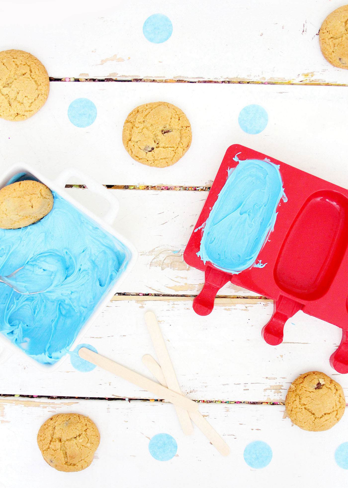 Adding blue melted candy melts to a cake popsicle mold