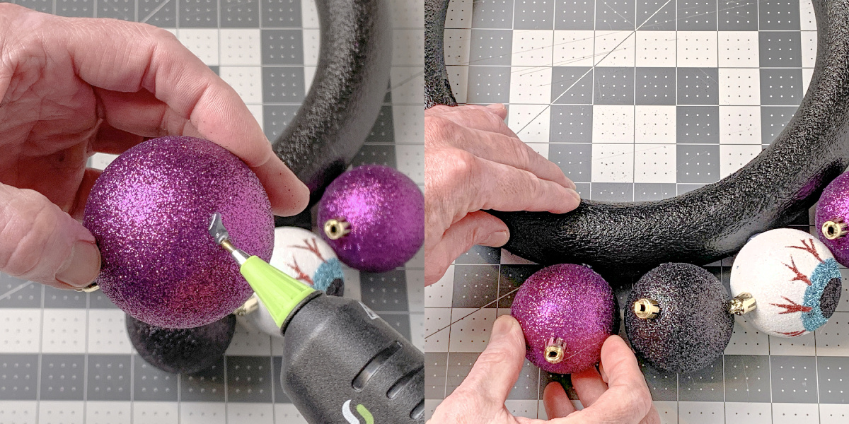 Adding hot glue to a purple glitter ornament and pressing it onto a wreath form