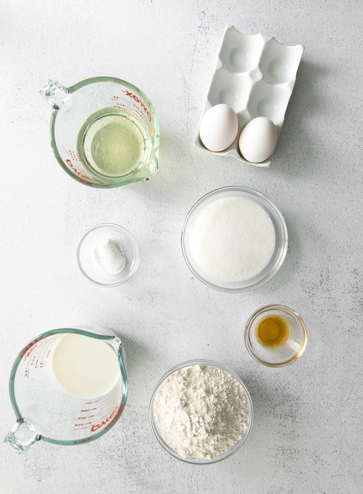 Flour, sugar, baking powder, vegetable oil, whole milk, eggs, and vanilla