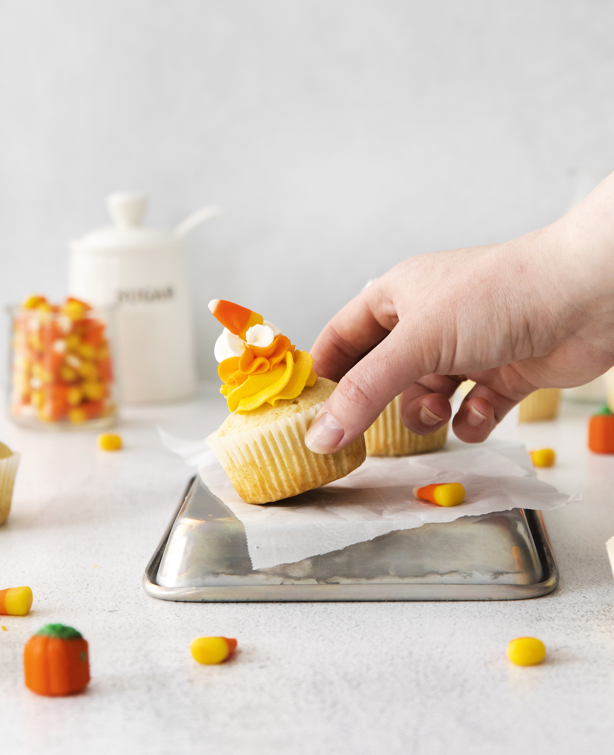 Hand grabbing a Halloween cupcake