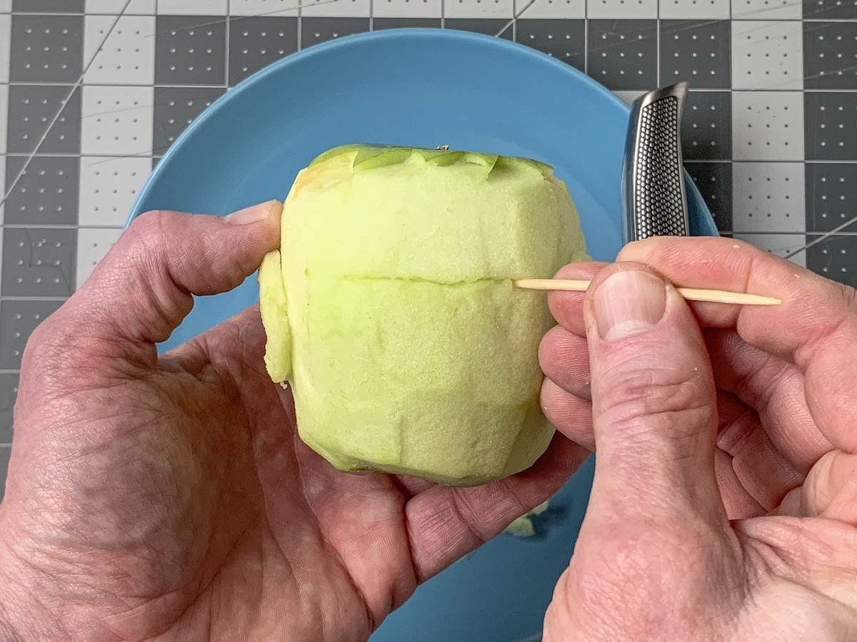 Making forehead lines on the apple with a toothpick