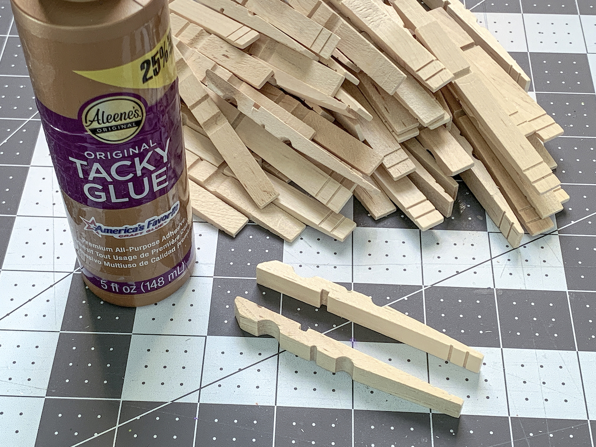 Pile of clothespins with a bottle of craft glue